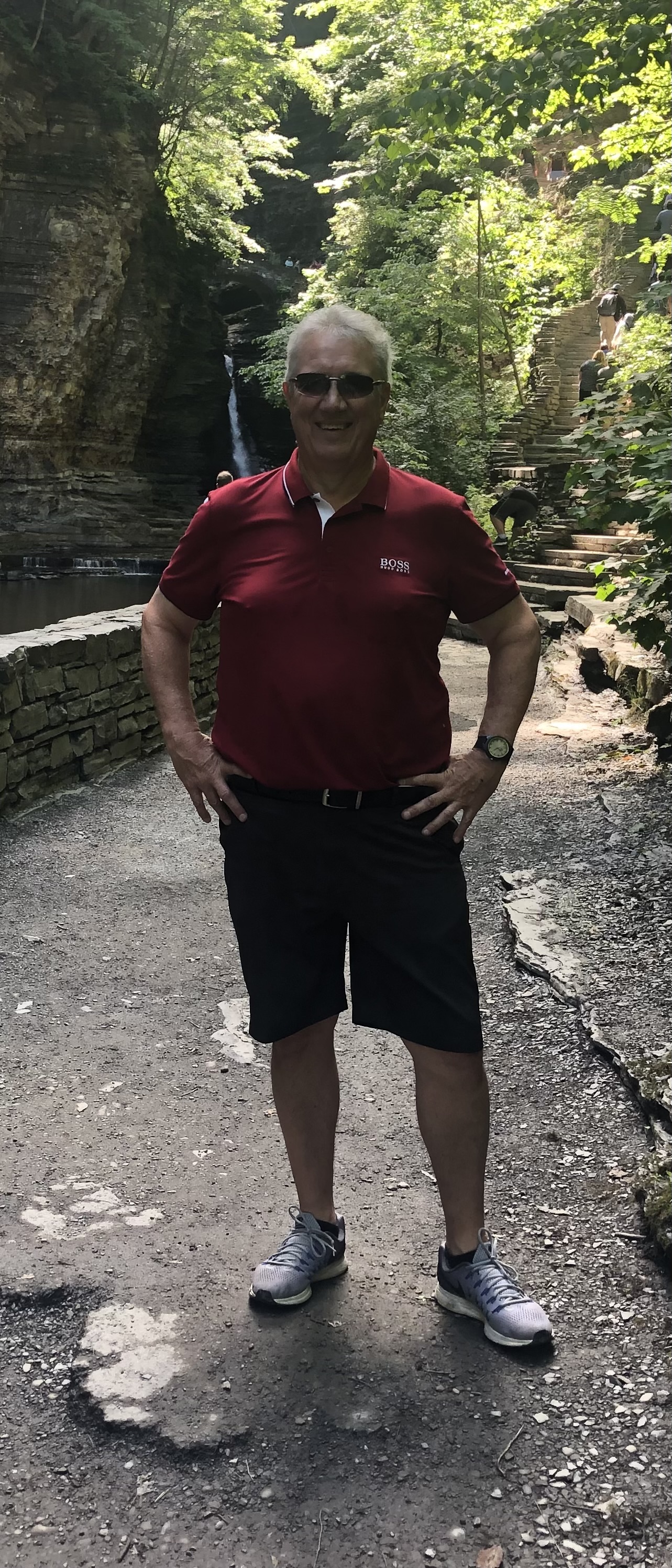Paul smiling in front of a waterfall